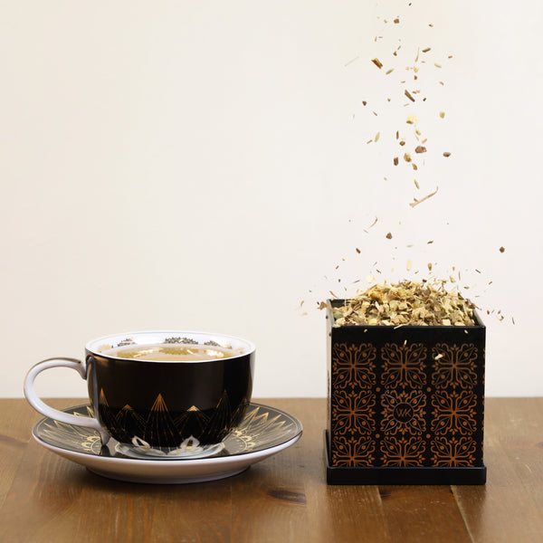 Anti-Strain loose leaf tea being poured into tea tin.