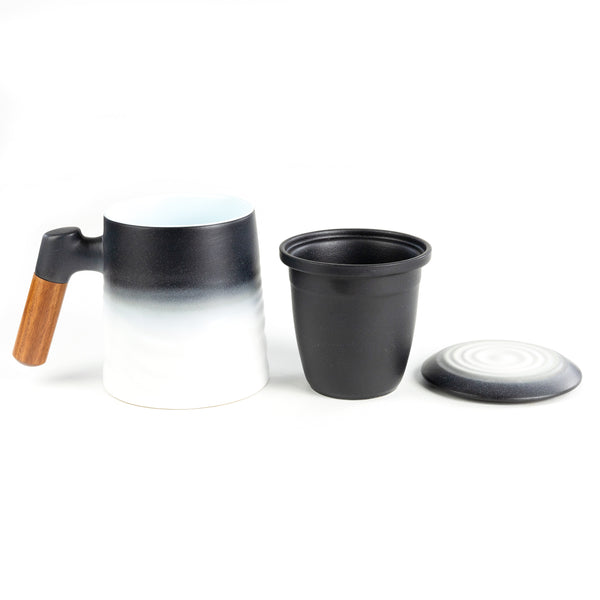 A Whistling Kettle Wave Mug next to its infuser and lid