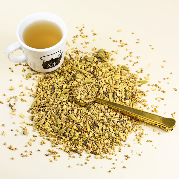 Cup of Stimulating next to mound of Stimulating loose leaf tea.