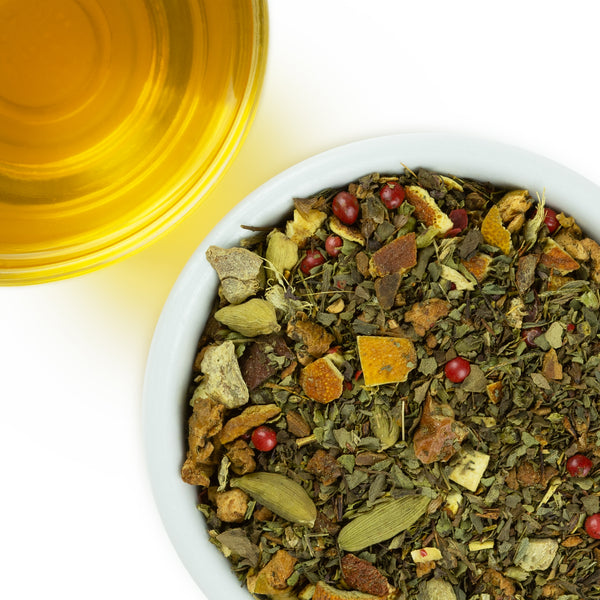 Loose leaf Serenity tea next to a brewed cup