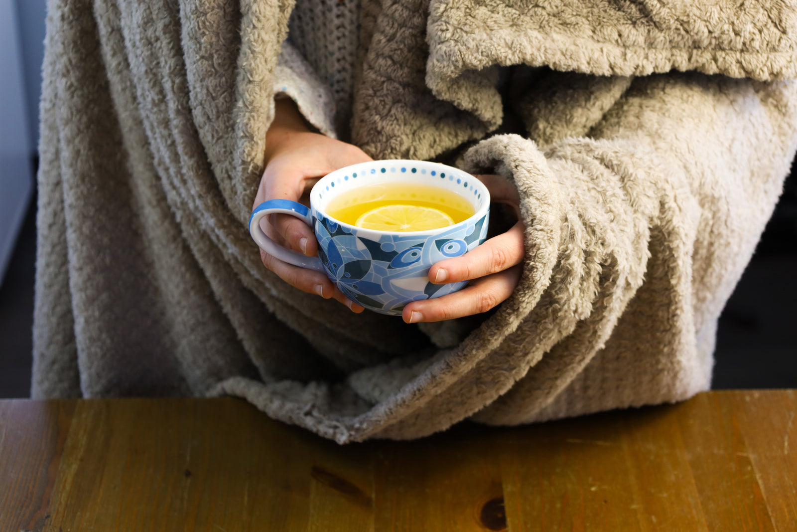 Holding a teacup full of medicine ball tea