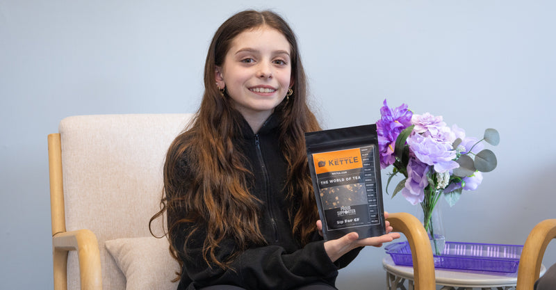 Drea holding a bag of sip for cf