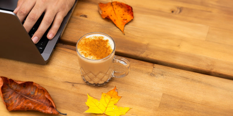 Hot Chai Latte outside on patio next to fall leaves