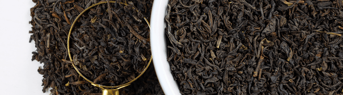 Loose leaf black tea in a bowl.