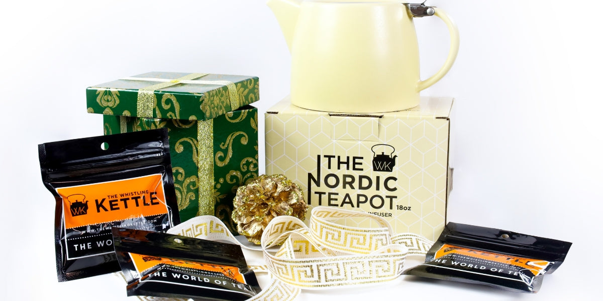 Tea samples and teapot next to a holiday gift box