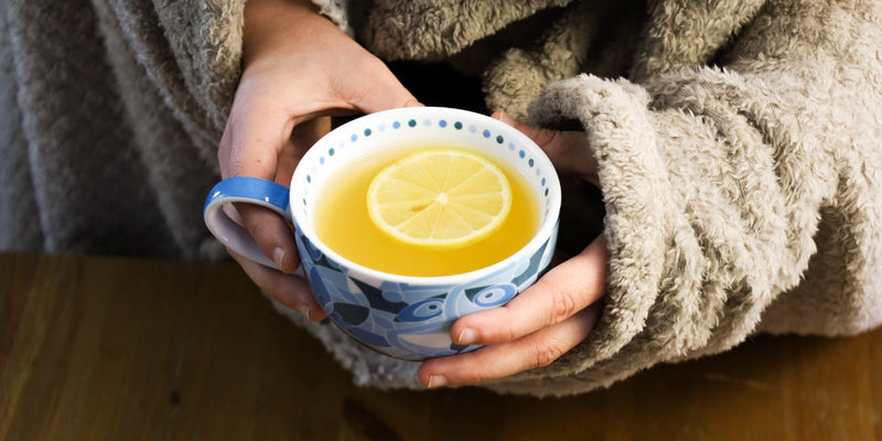 Holding Medicine Ball Tea, wrapped in a blanket