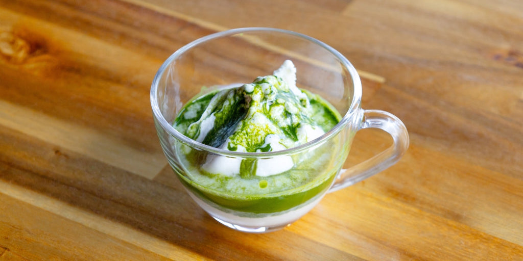 Matcha affogato in a clear glass cup