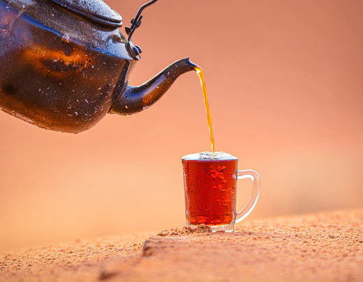 tea pot pouring tea in to a mug 