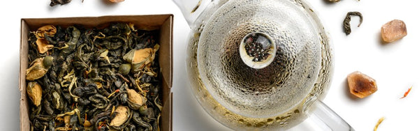 Green tea leaves with a tea pot
