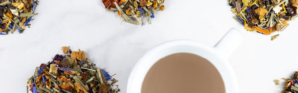 Mounds of tea leaves surround a tea cup