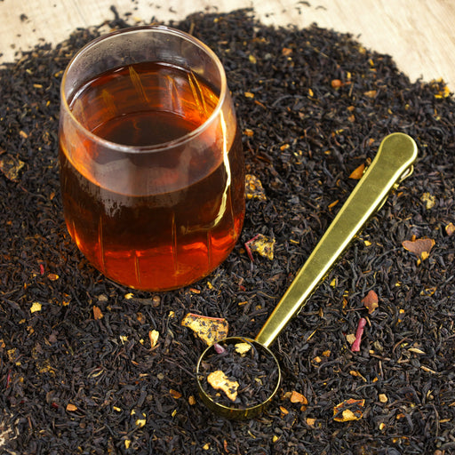 Glass of Apple Cider Donut tea on top of Apple Cider Donut tea leaves.