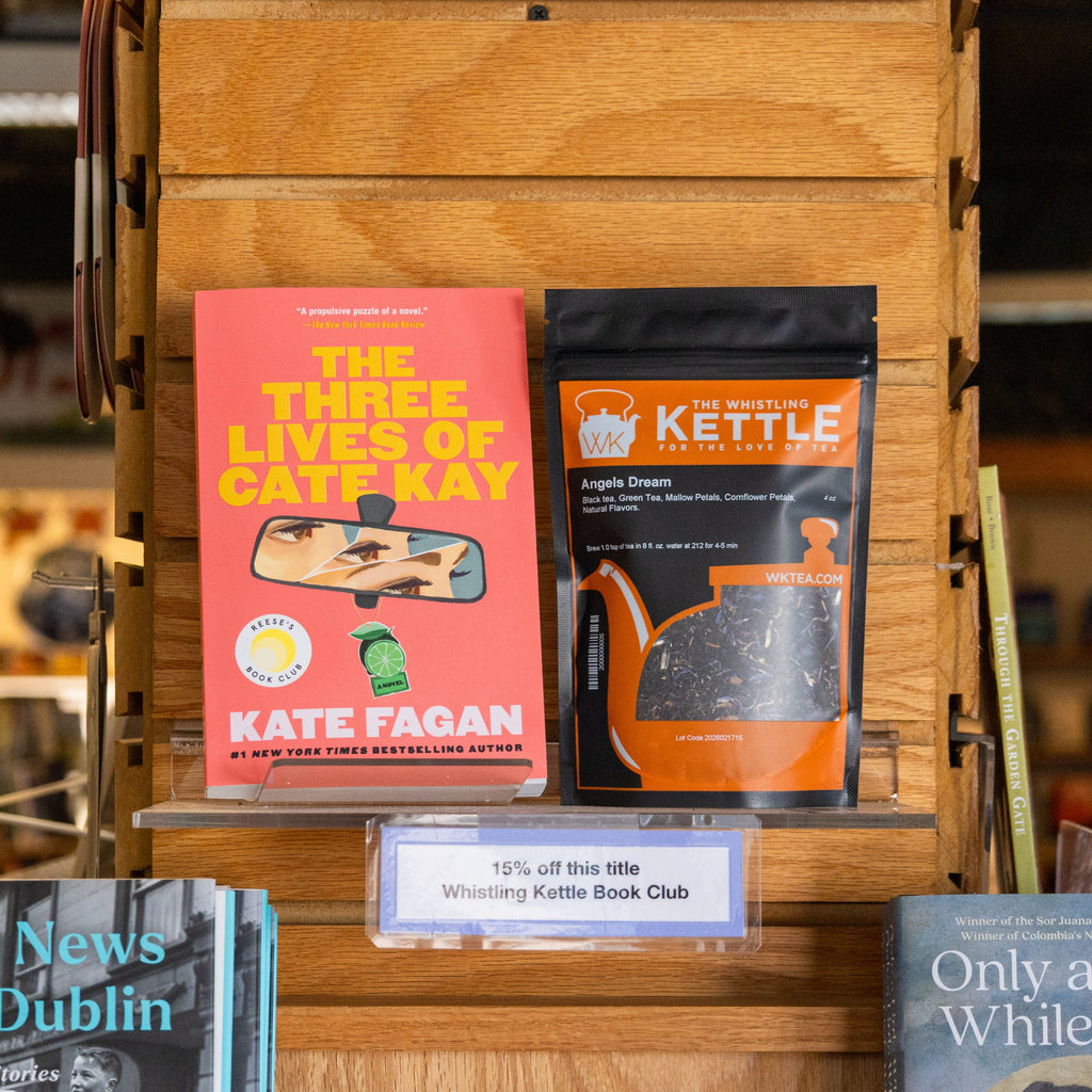 The Three Lives of Cate Kay paperback book next to a 4oz bag of Angels Dream blackberry maple black tea