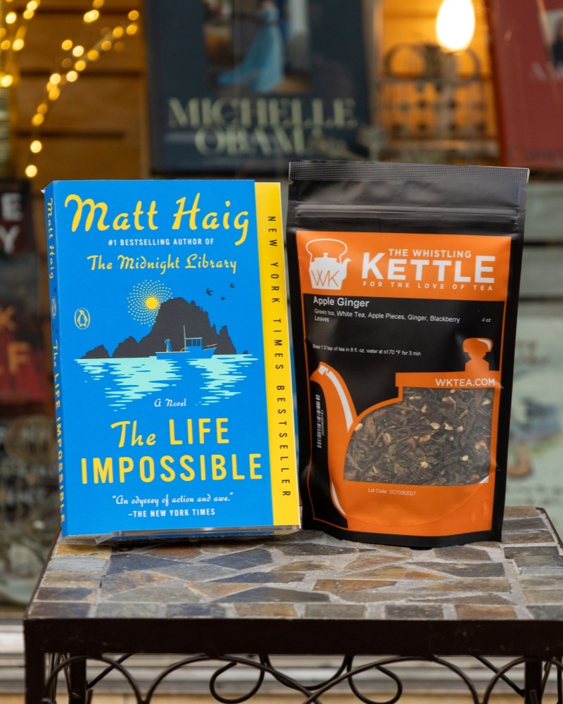the life impossible book next to apple ginger loose leaf tea