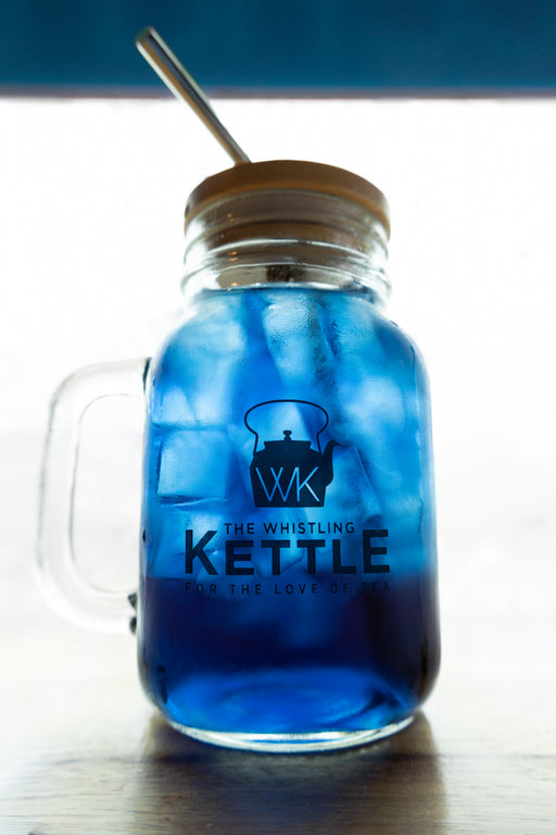 Iced Butterfly Pea Flower tea with a brilliant sapphire-blue hue, served over ice in a mason jar