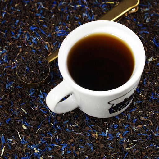Cup of Decaf Earl Grey on top of mound of Decaf Earl Grey loose leaf tea.