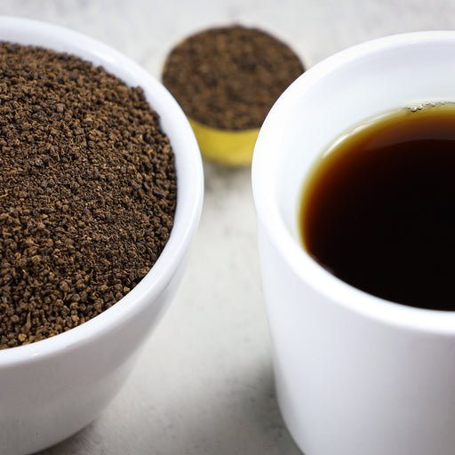 Cup of Decaf Irish Breakfast tea next to bowl of Decaf Irish Breakfast loose leaf tea.