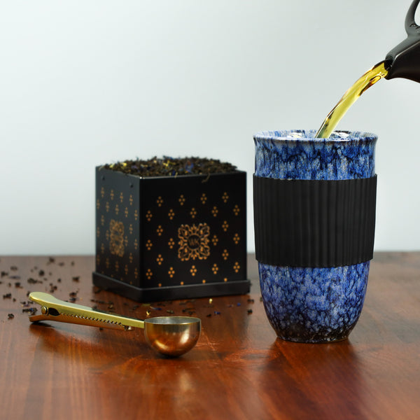 Brewed Earl Grey being poured into Ceramic Bird's Egg Travel Mug.