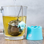 Blue Whistling Kettle "The Egg" Stainless Steel Tea Ball Infuser with Drip Tray in water.
