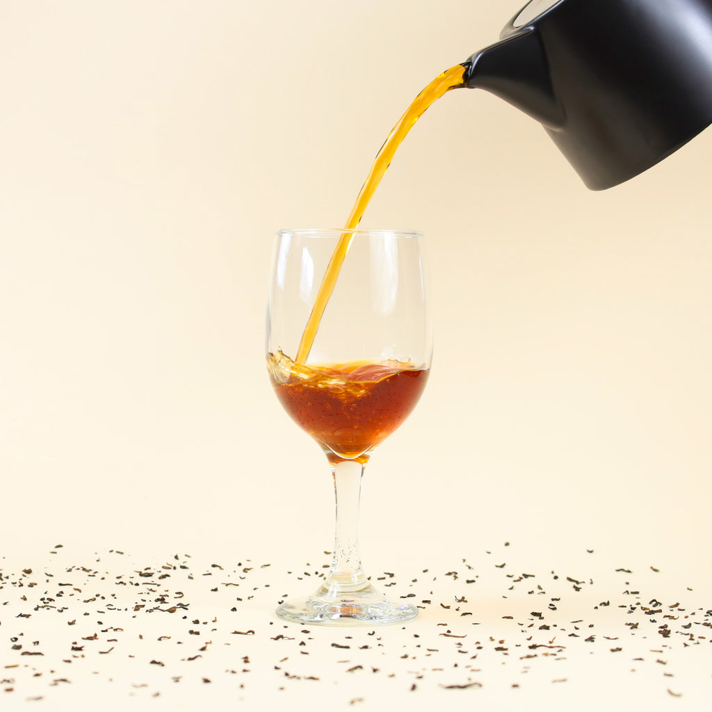 Brewed Golden Pu-Erh being poured into glass.