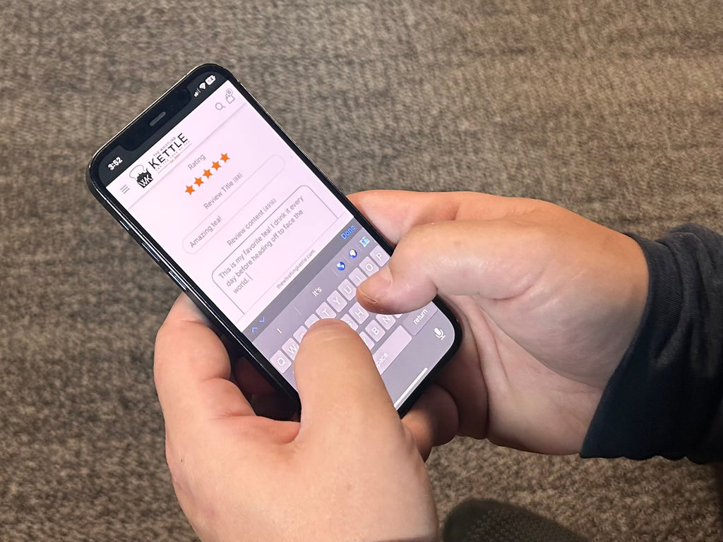Person holding a smartphone with an app open on a textured surface