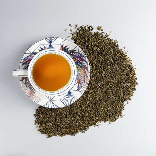 Cup & Saucer of brewed Moroccan Mint next to Moroccan Mint loose leaf tea.