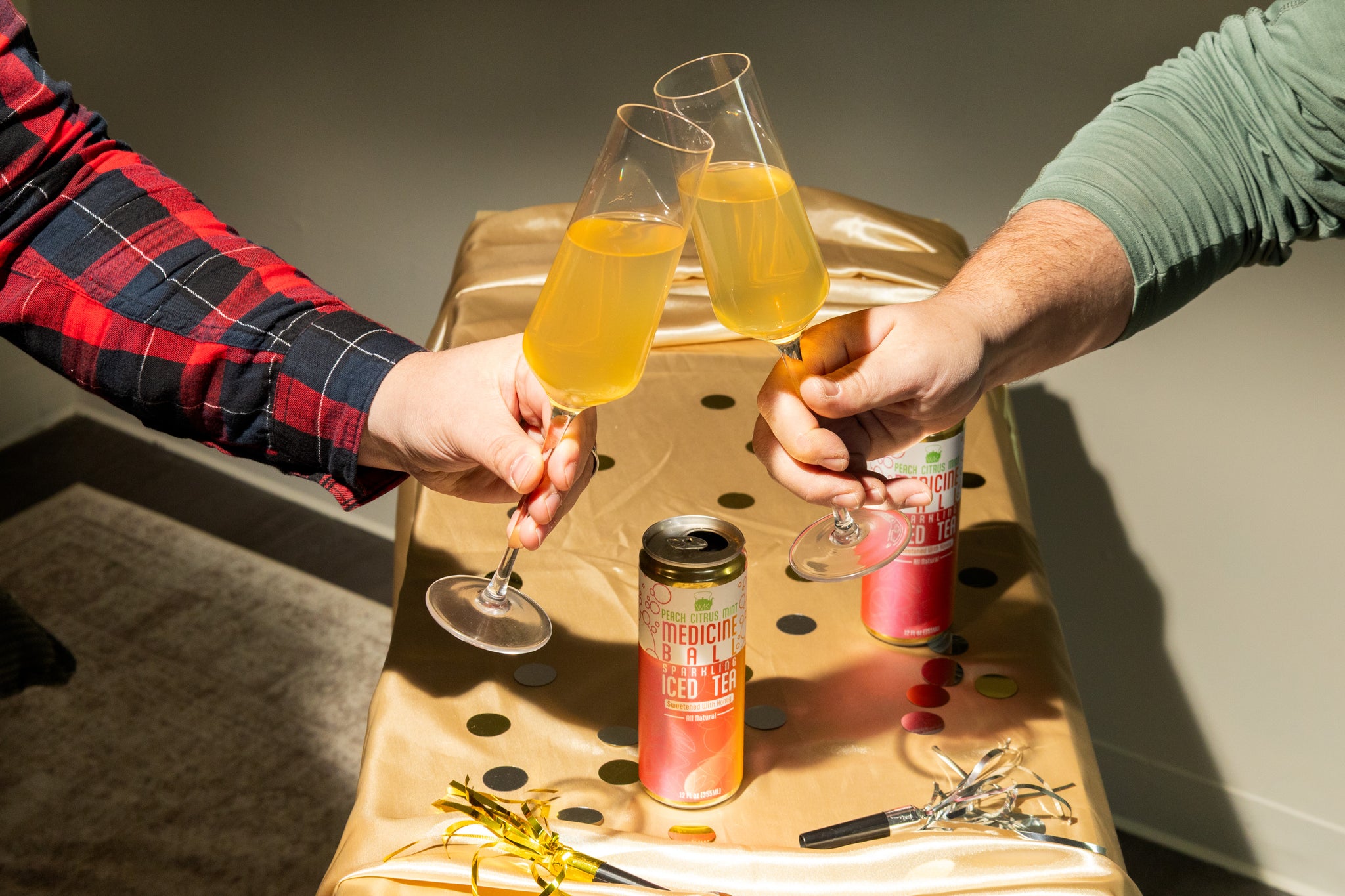 Clinking flute glasses filled with sparkling medicine ball tea