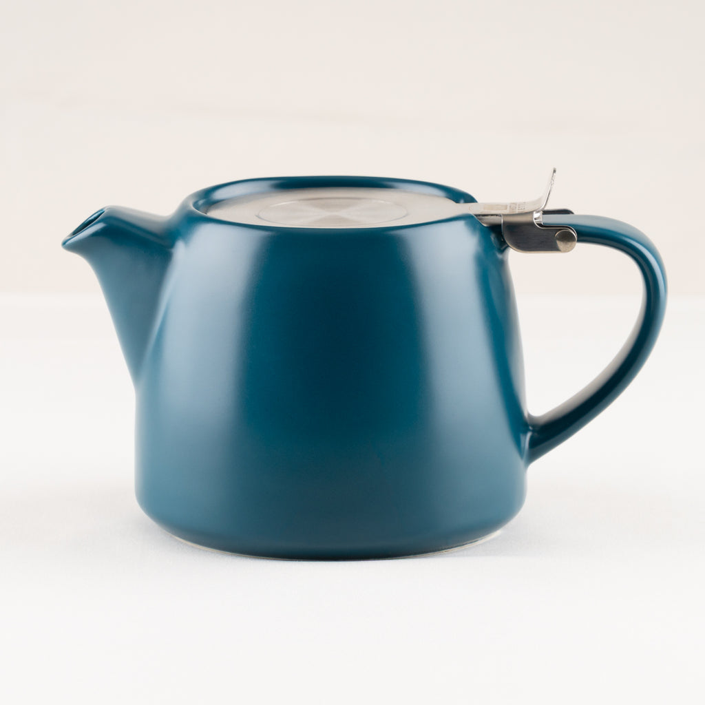 Blue teapot with a lid on a white background.