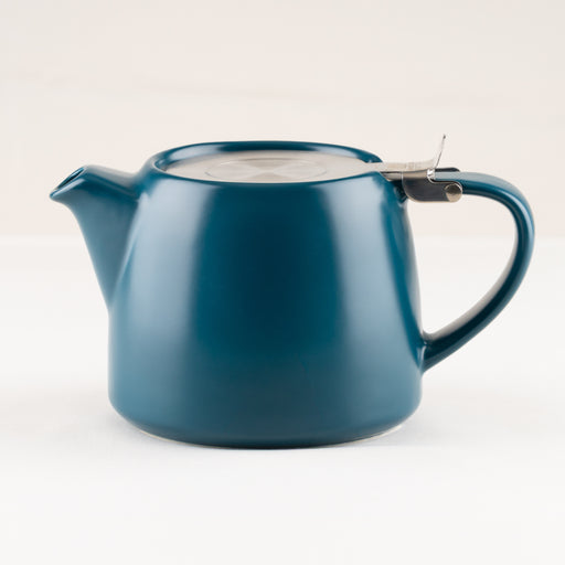 Blue teapot with a lid on a white background.