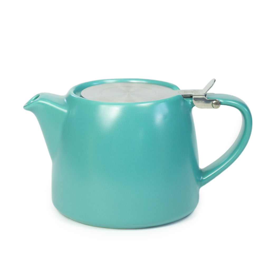 Turquoise teapot with a silver infuser on a white background.