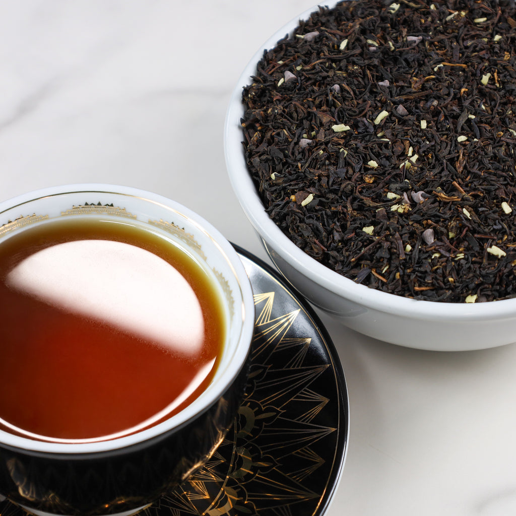 Cup & Saucer filled with brewed Salted Caramel Chocolate next to bowl of Salted Caramel Chocolate loose leaf tea.