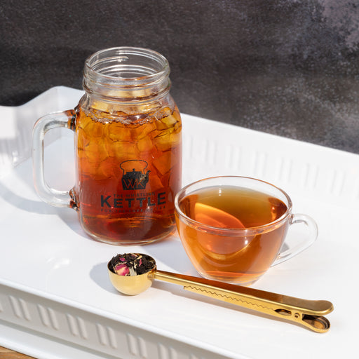 Picture of mason jar with sweet iced Strawberry Dragonfruit tea and glass of hot tea with a scoop