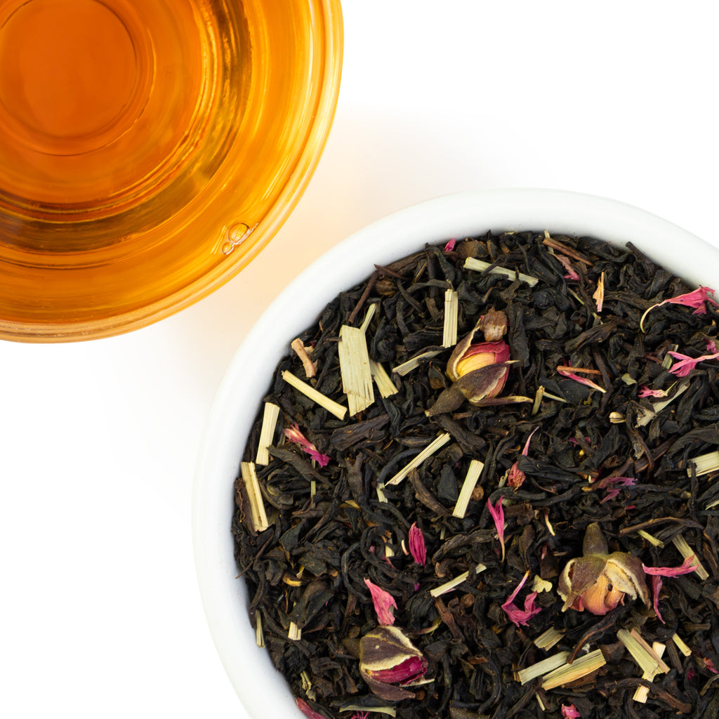 Sweet Strawberry loose leaf tea in an overhead shot with infusion of tea in glass cup