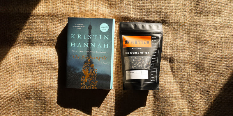 A paperback copy of The Nightingale lays next to a bag of Lavender Earl Grey Tea