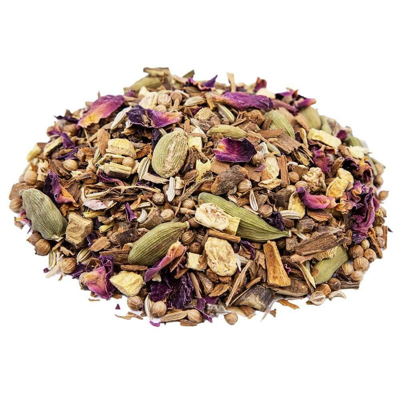 Side mound shot of The Whistling Kettle Balancing tea with cinnamon pieces, cardamom, licorice roots, coriander, fennel, ginger roots, rose leaves, and licorice root.