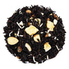 Above mound shot of The Whistling Kettle's Celebration black tea with banana, cinnamon, almond, macaroon coconut, candied pineapple, white chocolate, and white sugar.