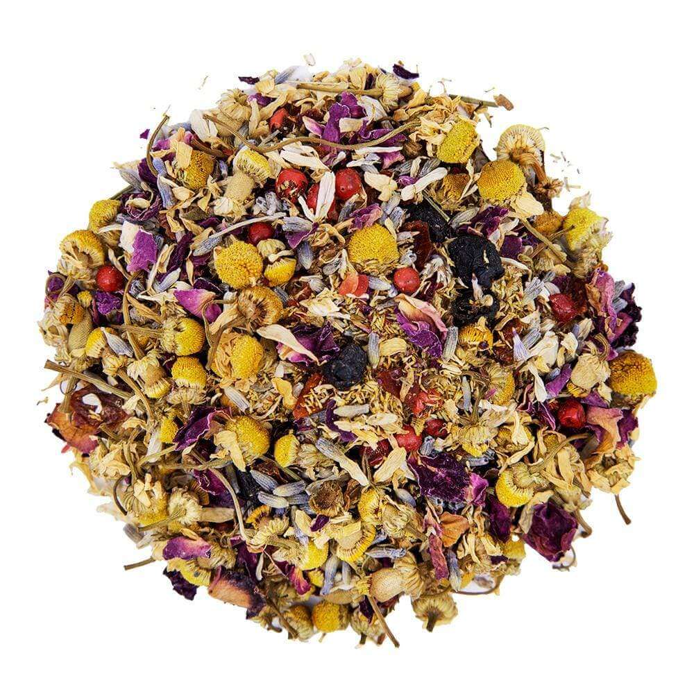 Top mound picture of The Whistling Kettle Chamomile Bilberry Bliss tea with chamomile flowers, rose petals, pink peppercorns, lavender and bilberries.