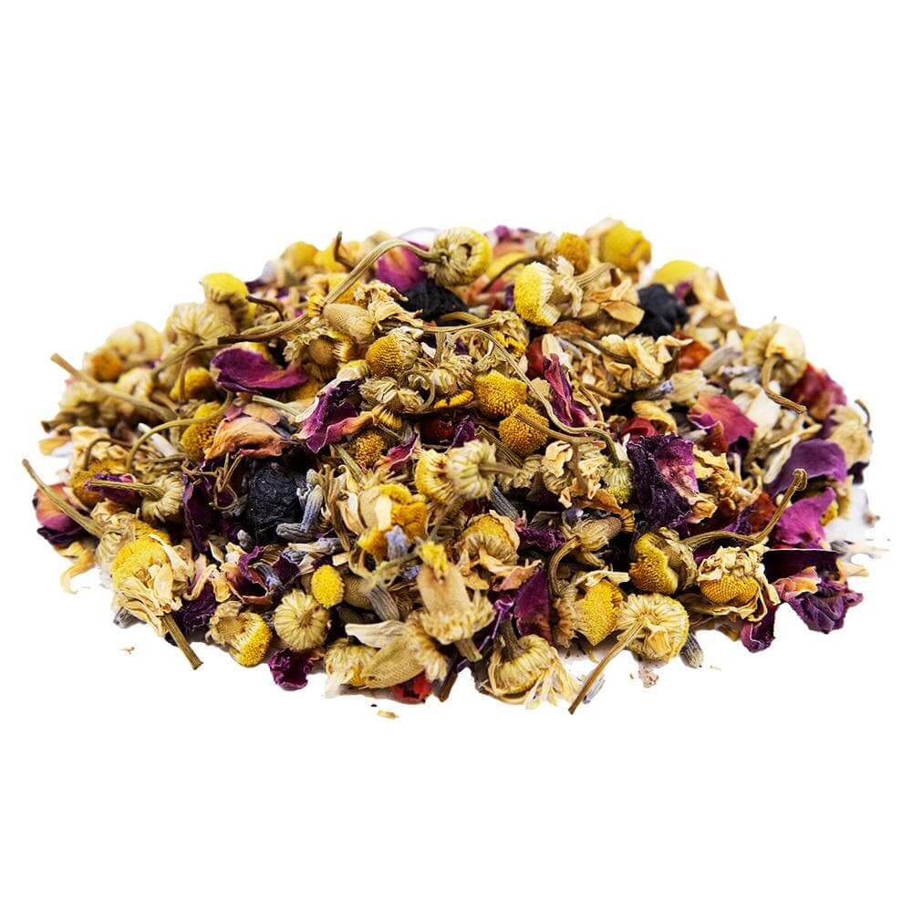 Side mound picture of The Whistling Kettle Chamomile Bilberry Bliss tea with chamomile flowers, rose petals, pink peppercorns, lavender and bilberries.