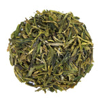 Top mound picture of The Whistling Kettle Dragonwell Lung Ching green tea with long vibrant leaves.