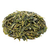 Side mound picture of The Whistling Kettle Dragonwell Lung Ching green tea with long vibrant leaves.