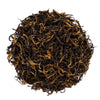 Top mound photo of The Whistling Kettle Golden Monkey black tea leaves with golden tips.