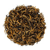 Top mound photo of The Whistling Kettle Golden Yunnan black tea with long golden tipped tea leaves.