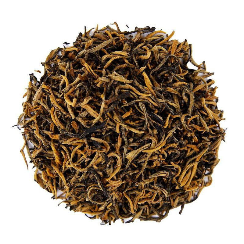 Top mound photo of The Whistling Kettle Golden Yunnan black tea with long golden tipped tea leaves.