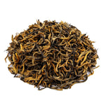 Side mound photo of The Whistling Kettle Golden Yunnan black tea with long golden tipped tea leaves.