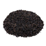 Side mound picture of The Whistling Kettle Keemun Panda black tea leaves.