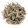 Top mound picture of The Whistling Kettle King of Silver Needles white tea with long white tea leaves.