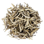 Top mound picture of The Whistling Kettle King of Silver Needles white tea with long white tea leaves.