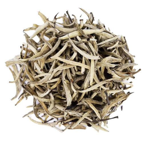 Top mound picture of The Whistling Kettle King of Silver Needles white tea with long white tea leaves.