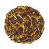 Above mound shot of The Whistling Kettle's Lemon Souffle rooibos tea with honeybush, green rooibos, lemon peel, orange peel, calendula petals, and blue cornflowers.