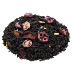 Side mound picture of The Whistling Kettle Pomegranate Cranberry tea with dried cranberry, raspberry, pomegranate, and rose petals.
