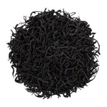 Top mound picture of The Whistling Kettle Secret Village black tea with long curled leaves.